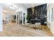 Bright and open living space with a modern fireplace, wood floors, and wine storage at 1350 Rossini St, Henderson, NV 89052