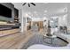 Spacious living area showcasing an open layout with modern decor, a kitchen island, and hardwood flooring at 1350 Rossini St, Henderson, NV 89052