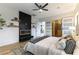 Comfortable main bedroom with modern fireplace, ceiling fan, and a glimpse of the walk-in closet at 1350 Rossini St, Henderson, NV 89052