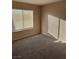 Bright bedroom featuring carpet flooring and a window with sunlight streaming through blinds at 1447 Hialeah Dr # B, Las Vegas, NV 89119