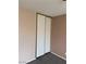 Bedroom featuring double sliding door closet and neutral walls and carpet flooring at 1447 Hialeah Dr # B, Las Vegas, NV 89119