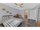 Comfortable bedroom with ceiling fan, wood floors, and stylish decor; bathroom visible at 1453 Blisworth Ct # 102, Las Vegas, NV 89102