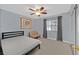 Bedroom with carpet, ceiling fan, and a large window, providing a bright and airy atmosphere at 1453 Blisworth Ct # 102, Las Vegas, NV 89102