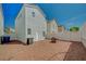 Expansive backyard features minimalist landscaping, a white privacy fence and an outdoor A/C unit at 1531 Evening Spirit Ave, Las Vegas, NV 89183