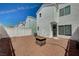 Spacious backyard with white fences, rock ground cover, and a charming fire pit ready for entertaining at 1531 Evening Spirit Ave, Las Vegas, NV 89183