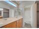 Bathroom featuring double sinks, vanity, walk-in closet access and combination bathtub/shower at 1531 Evening Spirit Ave, Las Vegas, NV 89183