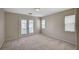 Spacious carpeted bedroom featuring a private balcony and natural light, creating a tranquil and inviting retreat at 1531 Evening Spirit Ave, Las Vegas, NV 89183