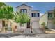 Charming two-story home featuring a white exterior, balcony, and attached garage, complemented by a neatly landscaped front yard at 1531 Evening Spirit Ave, Las Vegas, NV 89183