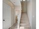 Hallway with tiled flooring and carpeted stairs leading to the upper level, providing a functional transition between floors at 1531 Evening Spirit Ave, Las Vegas, NV 89183