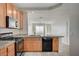 Efficient kitchen layout with granite countertops, black appliances, and plenty of storage space, designed for culinary convenience at 1531 Evening Spirit Ave, Las Vegas, NV 89183