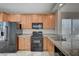 Well-equipped kitchen with light wood cabinetry, granite counters, and modern appliances, creating a delightful cooking experience at 1531 Evening Spirit Ave, Las Vegas, NV 89183