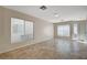 Bright living room with neutral walls, tile flooring, and large windows offering ample natural light for comfortable living at 1531 Evening Spirit Ave, Las Vegas, NV 89183
