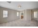 Spacious main bedroom with neutral carpet, two windows and ensuite bathroom access at 1531 Evening Spirit Ave, Las Vegas, NV 89183