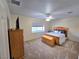 Comfortable carpeted bedroom with window, TV and dresser at 2065 Pinion Springs Dr, Henderson, NV 89074