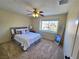 Bright carpeted bedroom with window view and full-length mirror at 2065 Pinion Springs Dr, Henderson, NV 89074