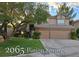 Inviting two-story home featuring a well-manicured lawn and a spacious three-car garage at 2065 Pinion Springs Dr, Henderson, NV 89074