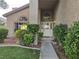 Charming front entrance with landscaped bushes and a well-lit doorway at 2065 Pinion Springs Dr, Henderson, NV 89074