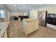 Modern kitchen with island, stainless appliances, and bright lighting at 2065 Pinion Springs Dr, Henderson, NV 89074