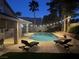 Night view of backyard featuring a sparkling pool, spa, and ambient string lights at 2065 Pinion Springs Dr, Henderson, NV 89074