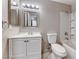 Simple bathroom with a vanity, mirror, toilet, and tub-shower combination with tile surround at 211 Mission Laguna Ln # 205, Las Vegas, NV 89107