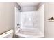 Close up of a bathtub with a white, molded enclosure, a shower head, and chrome fixtures at 211 Mission Laguna Ln # 205, Las Vegas, NV 89107