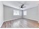 Spacious bedroom with neutral walls, wooden floors, a modern ceiling fan and natural light from the windows at 211 Mission Laguna Ln # 205, Las Vegas, NV 89107