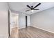 Large bedroom with gray walls and wood-look flooring, leading to bathroom and closet areas at 211 Mission Laguna Ln # 205, Las Vegas, NV 89107