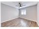Neutral bedroom with gray walls, window blinds, and wood-look flooring at 211 Mission Laguna Ln # 205, Las Vegas, NV 89107