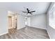 This bedroom features sleek gray walls, wood-look flooring, and a modern ceiling fan with lighting at 211 Mission Laguna Ln # 205, Las Vegas, NV 89107