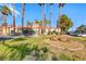 Community clubhouse surrounded by palm trees, offering a gathering space for residents at 211 Mission Laguna Ln # 205, Las Vegas, NV 89107