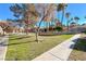 Exterior view of condo buildings with palm trees and lush lawns at 211 Mission Laguna Ln # 205, Las Vegas, NV 89107