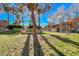 Exterior view of condo buildings with well-maintained lawns and mature trees at 211 Mission Laguna Ln # 205, Las Vegas, NV 89107