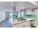 Open concept kitchen with stainless steel appliances, stylish cabinets, modern countertops and access to the living area at 211 Mission Laguna Ln # 205, Las Vegas, NV 89107