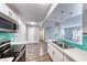 Well-lit kitchen featuring stainless appliances, white cabinets, updated countertops and convenient access to the dining area at 211 Mission Laguna Ln # 205, Las Vegas, NV 89107