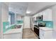Bright kitchen featuring stainless steel appliances, white cabinets, and modern countertops and a teal backsplash at 211 Mission Laguna Ln # 205, Las Vegas, NV 89107