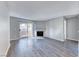View of the living room with wood-look flooring, fireplace, and access to the exterior balcony at 211 Mission Laguna Ln # 205, Las Vegas, NV 89107