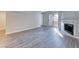 Living room with wood-look flooring and fireplace and sliding glass door to a patio at 211 Mission Laguna Ln # 205, Las Vegas, NV 89107