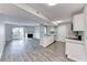 Open floor plan with fireplace, sliding glass door, and kitchen with stainless appliances at 211 Mission Laguna Ln # 205, Las Vegas, NV 89107
