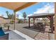 Picturesque backyard featuring a covered dining area, desert landscaping, and a comfortable seating space at 2111 River City Dr, Laughlin, NV 89029