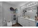 Bathroom with double vanity sinks, large mirror, and neutral walls at 2111 River City Dr, Laughlin, NV 89029