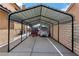 Carport protecting vehicles and trailers from the elements with concrete pad and brick wall at 2111 River City Dr, Laughlin, NV 89029