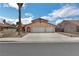 Charming home with a large driveway, a two-car garage, and low-maintenance desert landscaping at 2111 River City Dr, Laughlin, NV 89029