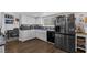 Bright kitchen features white cabinets, stainless steel appliances, and eat in dining area at 2111 River City Dr, Laughlin, NV 89029