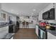 Spacious kitchen with modern appliances, white cabinets, and a breakfast bar seating area at 2111 River City Dr, Laughlin, NV 89029