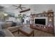 Inviting living room with a fireplace, mounted tv, and plush seating for a comfortable living space at 2111 River City Dr, Laughlin, NV 89029