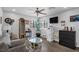 Cozy living room with hardwood floors, mini bar cabinet, and natural lighting at 2111 River City Dr, Laughlin, NV 89029