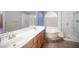 Bathroom featuring double sinks, a soaking tub, and a glass-enclosed shower at 220 Hollyfern St, Henderson, NV 89074