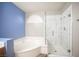 Bright bathroom with tub and newly tiled shower, providing a modern and stylish space at 220 Hollyfern St, Henderson, NV 89074