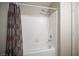 Clean bathroom showcasing a white tub, shower with tiled walls and decorative shower curtain at 220 Hollyfern St, Henderson, NV 89074