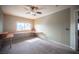 Bedroom with plush carpets, built-in desks and bright window, offering a versatile space at 220 Hollyfern St, Henderson, NV 89074